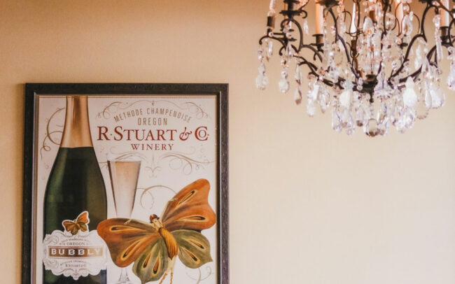 Chandelier and framed R. Stuart & Co Bubbly poster