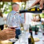 Pouring R. Stuart & Co wine into a glass at IPNC