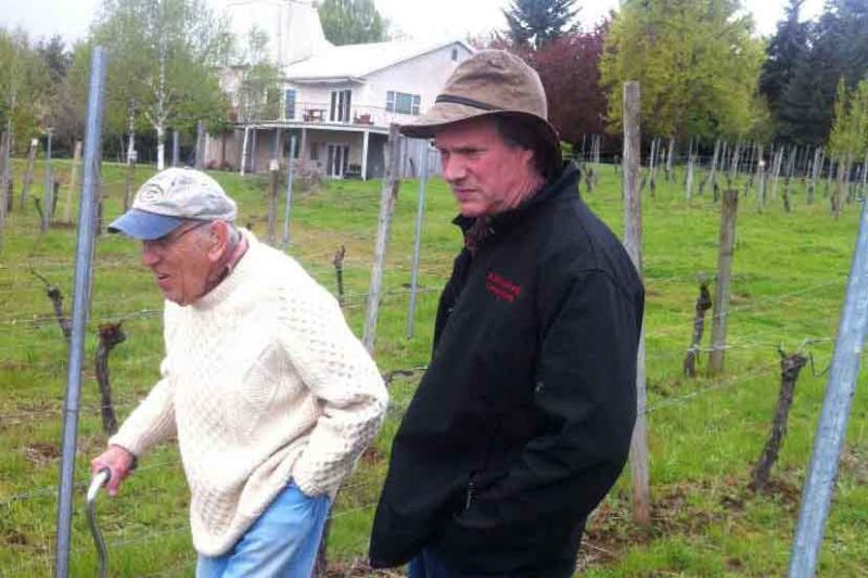 Jimmy and Rob walking through the vineyard